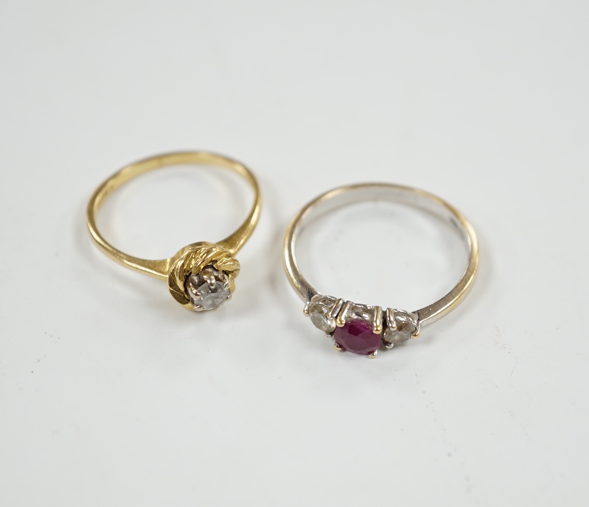 A modern 18ct white gold, ruby and diamond set three stone ring, size N/O and a 1970's 18ct gold and solitaire diamond set ring, size L, gross weight 5.3 grams.